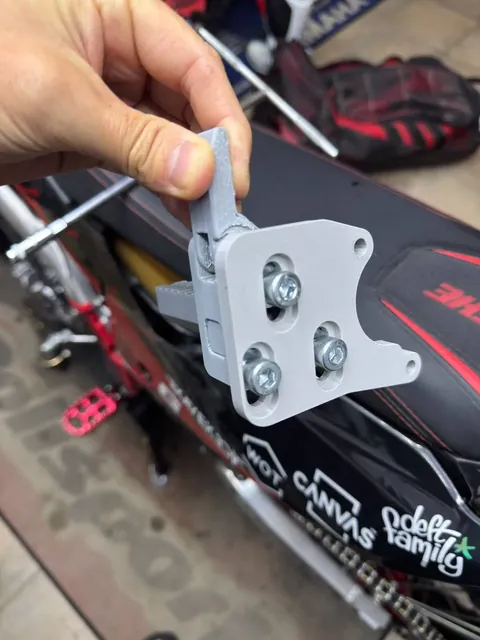 3D-printed prototype bracket held in hand before a test fit